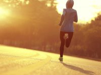 young fitness woman runner athlete running at  sunrise road